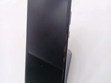a cell phone that is on a stand on a table