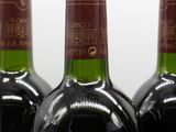 three bottles of wine sitting on top of a table next to each other