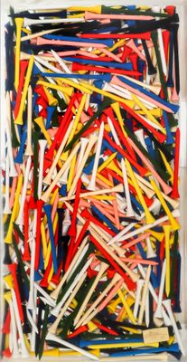 a close up of a box of assorted golf tees on a table