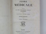 an open book on a white table with a black and white title