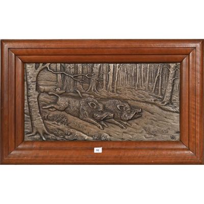 a bronze plaque depicting a boar and a boar in the woods