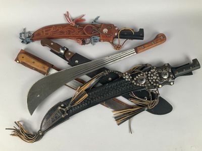 three different types of knives on a white surface