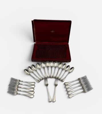 an assortment of silverware in a red case on a white surface