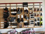 many bikes and bags hanging on the wall in the store