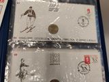 two sets of commemorative coins are in a blue box on a table