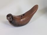 a small wooden bird that is sitting on a table