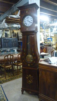 une horloge de parquet trônant au milieu d'une pièce
