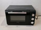 a black toaster oven sitting on a counter top