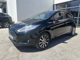a black ford fiesta parked in front of a building