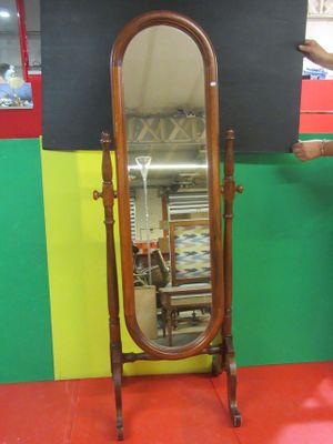 a mirror that is sitting on a stand in a room