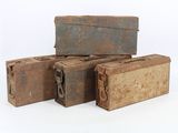 three old suitcases sitting on top of each other on a white surface