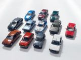 a lot of toy cars that are lined up on a table