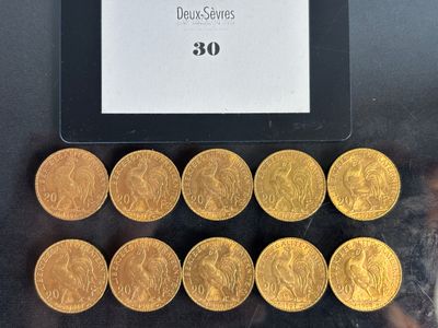 some gold coins are sitting on a black surface next to a tablet