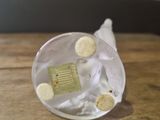 a close up of a small glass object on a table