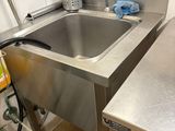 a sink in the kitchen with a faucet on the counter