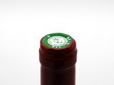 a close up of a bottle of wine on a white surface