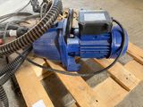 a blue pump sitting on top of a wooden pallet