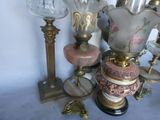 many different vases and lamps sitting on a table