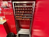 un mur rouge dans un magasin, avec une étagère remplie de bocaux