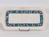 an image of a white platter with a blue border and flowers on it