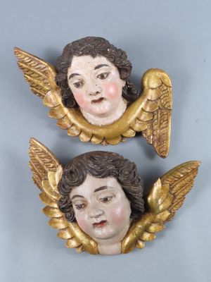 pair of antique angel heads on a blue background