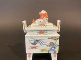 a small white box with a bird on it