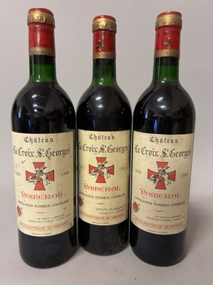 three bottles of red wine sitting next to each other on a table