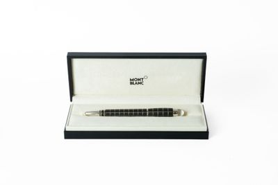 une image représentant un stylo posé dans une boîte sur une surface blanche