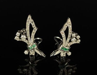 a pair of emerald and diamond earrings