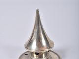 an image of a silver metal object on a white surface