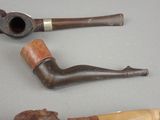 two pipes and a pipe holder on a table