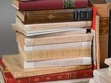 several books stacked on top of each other on a table