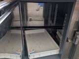 two trays of food sitting inside of an oven