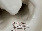 a close up of a white statue with writing on it