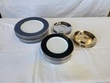 many plates and bowls on a table with a white table cloth