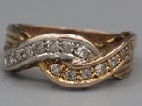 an image of a gold and diamond ring on a table