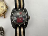 three watches that are sitting next to each other on a table