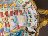 a plate with a painting on it on a table
