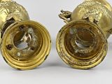 pair of antique brass candlesticks with lion heads on each side