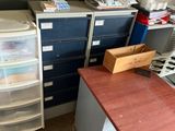 a desk with several drawers and a printer on it
