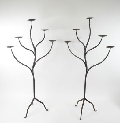 pair of black iron candelabs with candlesticks in the shape of trees
