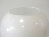 a white vase that is sitting on a table