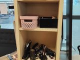 a book shelf with various items on it in a room