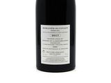 a bottle of wine that is sitting on a table