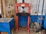 a machine that is sitting in a garage next to some boxes