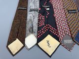 many different ties laid out together on a table