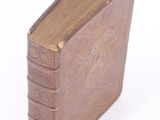 a small book that is sitting on a white surface