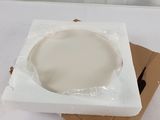 a white bowl sitting on top of a cardboard box on a table