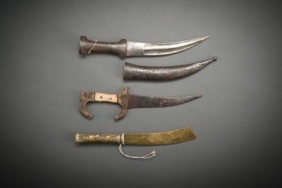 several different types of knives are displayed on a gray surface
