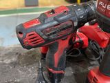 two electric tools sitting on top of a table in a workshop
